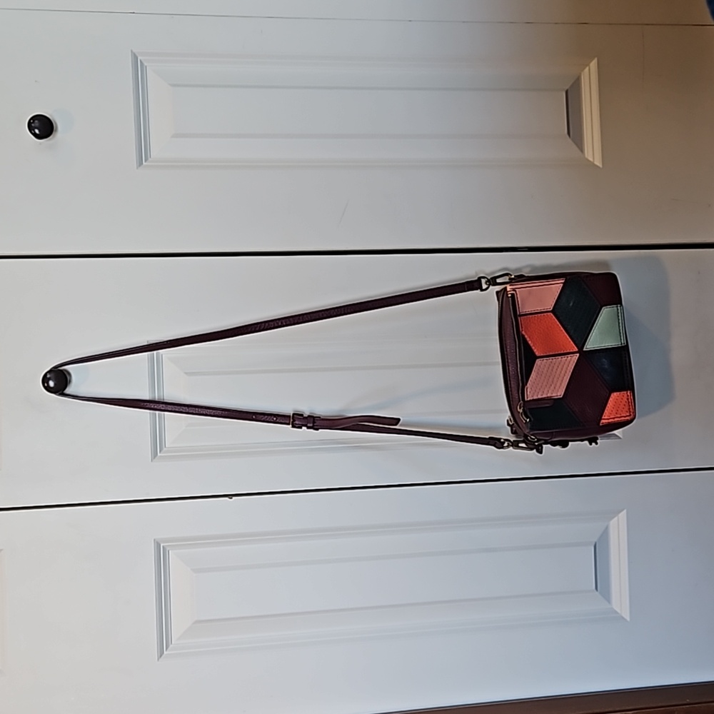 Fossil crossbody eggplant color purse.